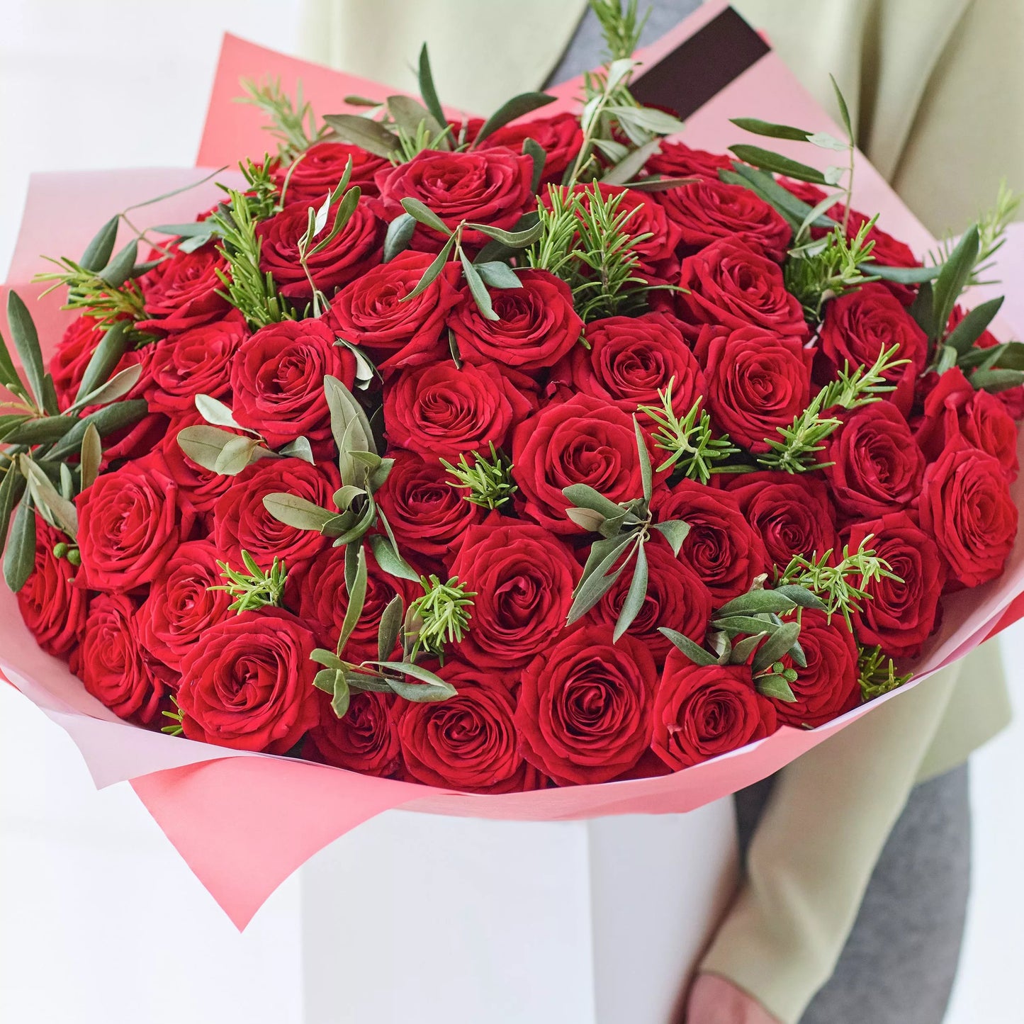 Love’s Essence: 51 Red Roses and Graceful Greenery