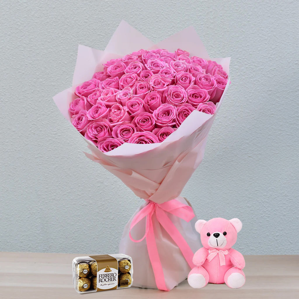 Celebrate love with our delightful bundle featuring 51 stems of exquisite pink roses, tenderly arranged to convey affection. Accompanied by cuddly teddy bears for warmth and decadent chocolates for sweetness, it's a gesture that speaks volumes. Perfect for expressing love, gratitude, or heartfelt sentiments on any special occasion.