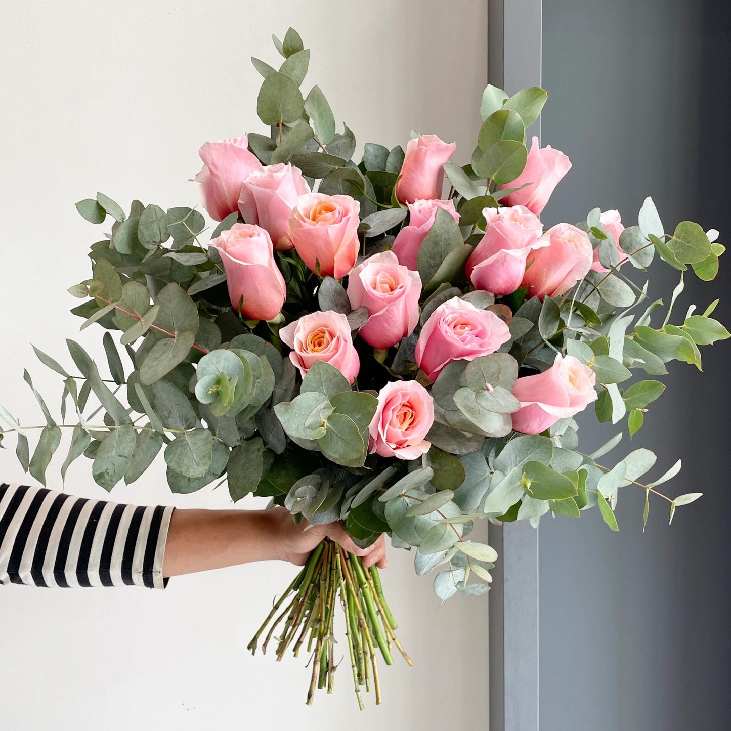 A beautifully arranged bouquet that comprises our Flamingo Pink roses paired with fragrant eucalyptus cinerea!