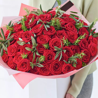 Love’s Essence: 51 Red Roses and Graceful Greenery