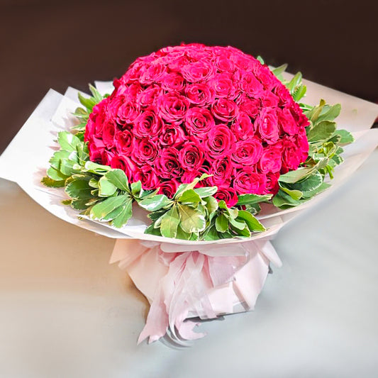 99 red roses bouquet, snow-on-the-mountain surrounding, white gauze wrapped pink crepe paper packaging, pink ribbon bow tied.