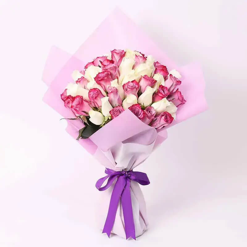 Discover the enchanting beauty of our Purple Roses and White Roses Bouquet. This exquisite arrangement blends the richness of purple roses with the purity of white roses, creating a mesmerizing display of elegance and grace. Perfect for expressing admiration, appreciation, or congratulations, it's a timeless gift that conveys heartfelt sentiments with style and sophistication.