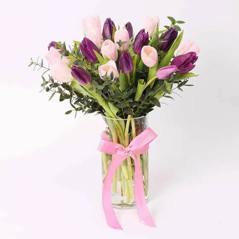 Embrace the essence of spring with our exquisite Tulip Bouquet. Each stem whispers tales of renewal and beauty, showcasing nature's delicate artistry. Vibrant hues dance in harmony, evoking a sense of joy and admiration. Whether as a gift of appreciation or a token of love, this bouquet is sure to infuse any space with warmth and charm.