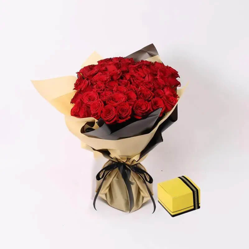 Elevate romance with our Red Roses Bouquet paired with delectable 250gm Chocolates. Each velvety bloom whispers love, while the rich chocolates add sweetness to every moment. Perfect for anniversaries, Valentine's Day, or any occasion where passion meets indulgence. Let this enchanting combination ignite hearts and create unforgettable memories.